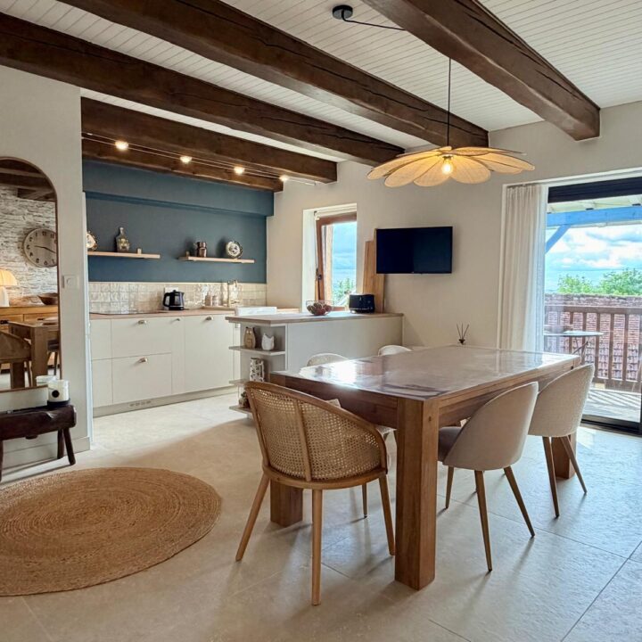 Architecture d’intérieur de pièce ouverte avec cuisine, salle à manger et accès au balcon.